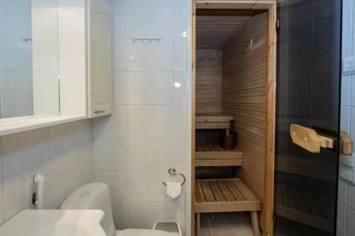 a small bathroom with a toilet and a shower at Moonlight 402 Levi in Sirkka