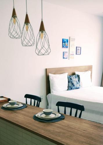 a room with a bed and a table with two cups at Mar Turquesa Eco Pousada in Maragogi