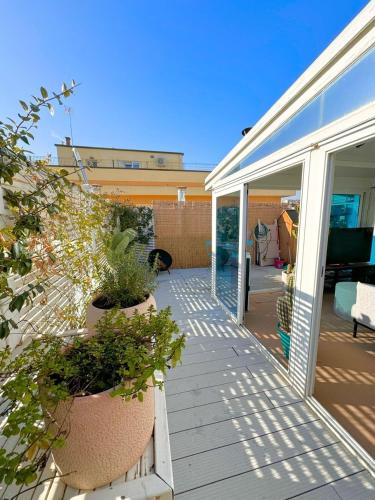 a patio with potted plants on a house at ROOFTOP-MarinaCentro-Unique-Beach-Fun-Smart-LoveApt-Train-Park in Rimini