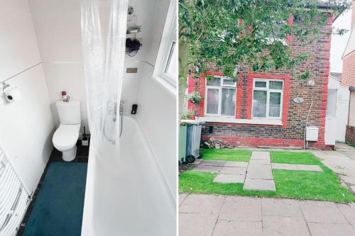 a bathroom with a toilet in front of a house at Cute Room - O2 & Excel Center in London