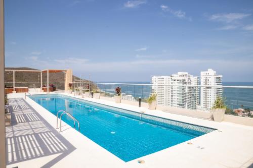 a swimming pool on the roof of a building at Beachside Bliss: Salguero Suites in Gaira