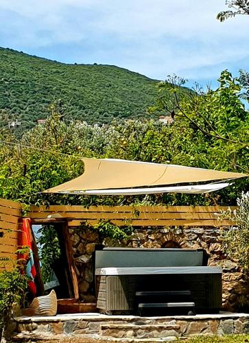 a stone building with a television and a roof at Cottage & private swimming pool in Poros