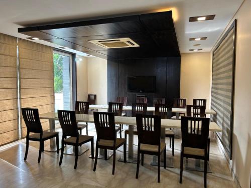 a conference room with a long table and chairs at Rao Regency in Gurgaon