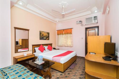 a hotel room with a bed and a television at Super Capital O Hotel Bidisha in Digha