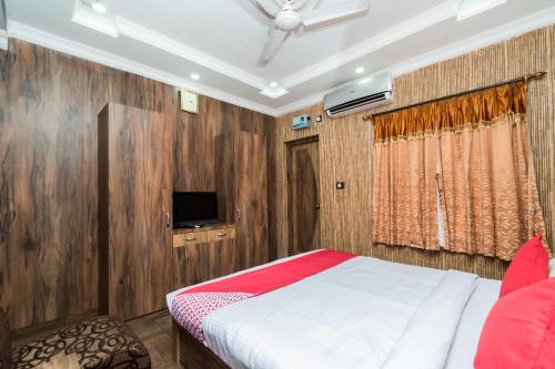 a bedroom with a bed and a tv in it at Capital O Bidisha in Digha