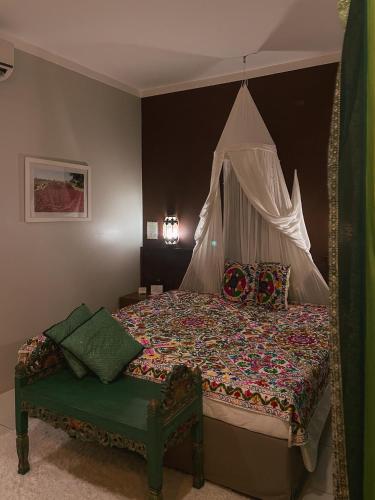 a bedroom with a large bed with a canopy at Taj Hotel in Três Lagoas