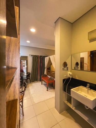 a bathroom with a sink and a mirror at Taj Hotel in Três Lagoas