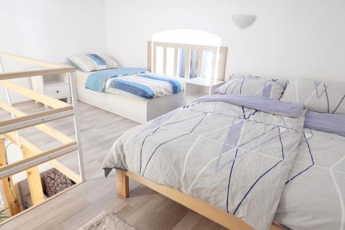 a bedroom with a bed and a bunk room with a ladder at Beli Kamik Apartments in Rijeka