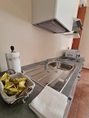 a kitchen counter with a sink and a stove at B&B Genti delle Alture in Apice