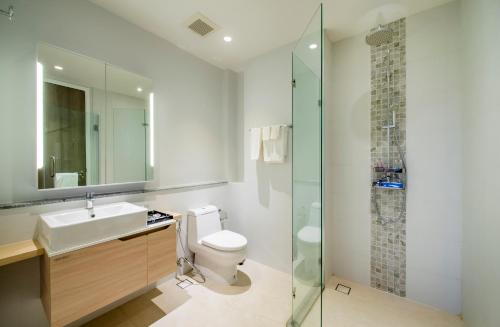 a bathroom with a toilet and a sink and a shower at 1 Bedroom Pool view at Diamond Resort in Bang Tao Beach