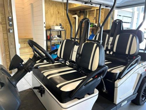 a golf cart with empty seats in a garage at Jailbreak in Southport
