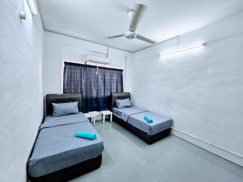 a room with two beds and a chalkboard at PANCHOR 6 HOSTEL in George Town
