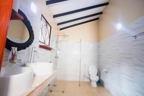 a bathroom with a sink and a toilet at Kijiji Beach Resort in Dar es Salaam