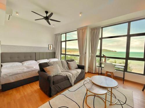 a bedroom with a bed and a couch and a table at imperium residence kuantan in Kuantan
