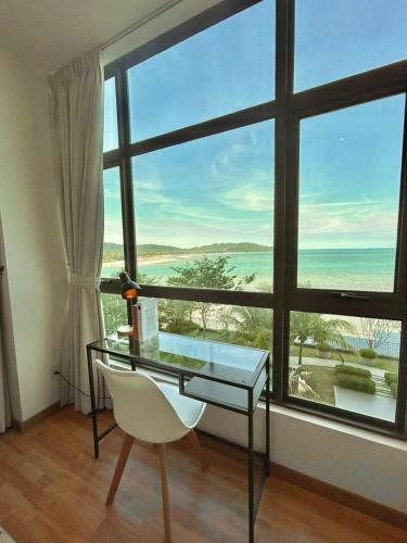 a desk and a chair in a room with a large window at imperium residence kuantan in Kuantan