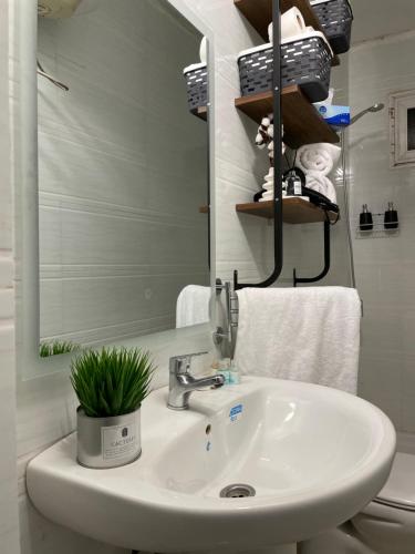 a bathroom with a sink and a mirror at Appart hôtel in Nouakchott