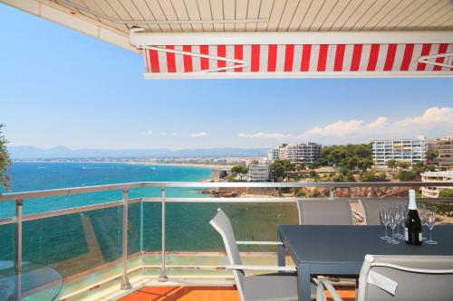 a balcony with a table and a view of the ocean at UHC Bahia Family Complex in Salou