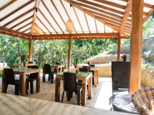 a group of tables and chairs in a pavilion at Hukumeizi Minca in Santa Marta