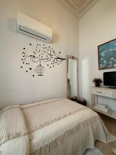 a bedroom with a bed with a bird cage on the wall at Alacati Zeynep Otel in Alacati