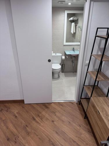 a bathroom with a toilet and a sink at Hotel Medicis in Barcelona