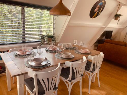 a dining room with a wooden table and chairs at Heerlijk vakantiehuis in bos bij Durbuy in Durbuy