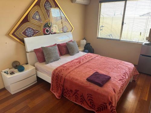 a bedroom with a bed with a large headboard at Radhe room in Perth
