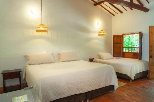 Ένα ή περισσότερα κρεβάτια σε δωμάτιο στο Hotel Hacienda Macedonia