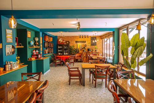 a restaurant with blue walls and tables and chairs at Chemodann Kazbegi in Kazbegi