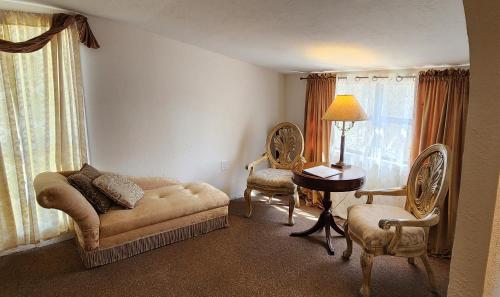 a living room with a couch and a table and chairs at Lily Creek Lodge in Dahlonega