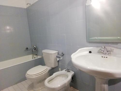 a bathroom with a white toilet and a sink at Casa da Ponte in Alvoco da Serra