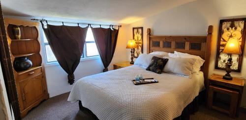 a bedroom with a large bed with a tray on it at Lily Creek Lodge in Dahlonega