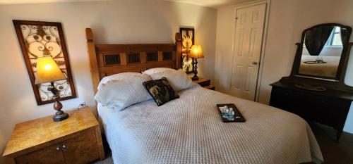a bedroom with a large white bed with a mirror at Lily Creek Lodge in Dahlonega