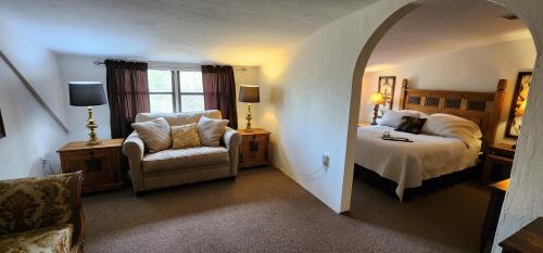 a bedroom with a bed and a chair in a room at Lily Creek Lodge in Dahlonega