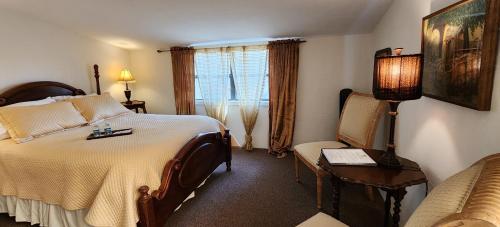 a hotel room with a large bed and a chair at Lily Creek Lodge in Dahlonega