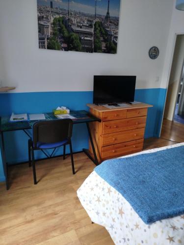 - une chambre avec un bureau, un ordinateur et un lit dans l'établissement Chambre rouge dans maison avec parking, à Cluses