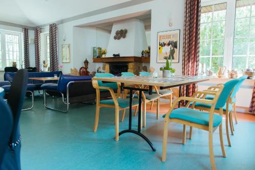 a dining room with a table and chairs at Hotel Pod Sosnami in Osieck