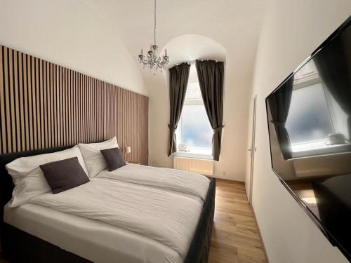 a bedroom with a bed and two windows at Beatrix Home Vienna Luxury Stay in Vienna