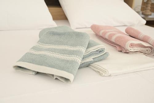 a pile of towels sitting on top of a table at Aurora Studio Apt for Couples & Friends in Heraklio Town