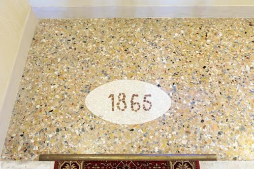 a tile floor with the word hbs on it at Villa Luccon - Mirano Centro Storico in Mirano