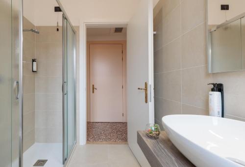 a bathroom with a tub and a sink and a shower at Villa Luccon - Mirano Centro Storico in Mirano