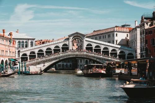 a bridge over a river in a city with boats at Villa Luccon - Mirano Centro Storico in Mirano
