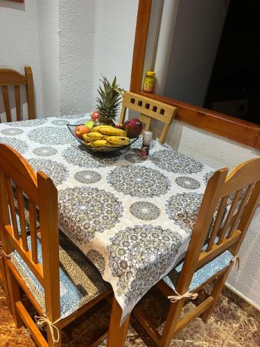 a table with a bowl of fruit on it at Habitación cerca a la playa. in Valencia
