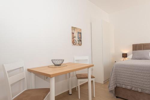 a small room with a table next to a bed at Apartments Lovrić in Vodice