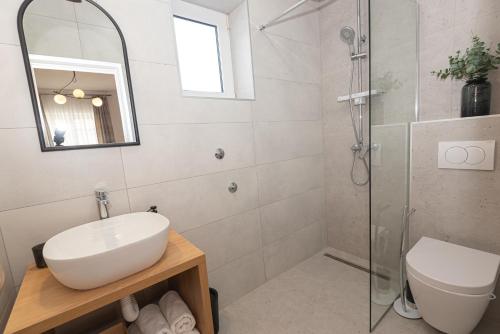 a bathroom with a sink and a shower at Apartments Lovrić in Vodice