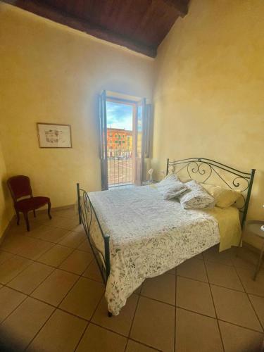 a bedroom with a bed and a window at La Casetta In Piazza in Sulmona