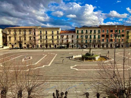 a large building with a fountain in the middle of a courtyard at La Casetta In Piazza in Sulmona