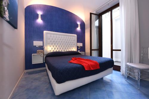 a bedroom with a bed with a red shirt on it at Casa Amalfi centro storico in Amalfi