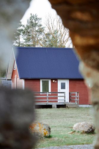 a red and white barn with a blue roof at Valleviken Hotell in Valleviken