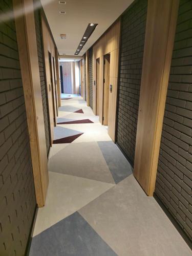 a hallway of a building with tile floors and walls at Hotel Vojvoda Putnik in Vranje