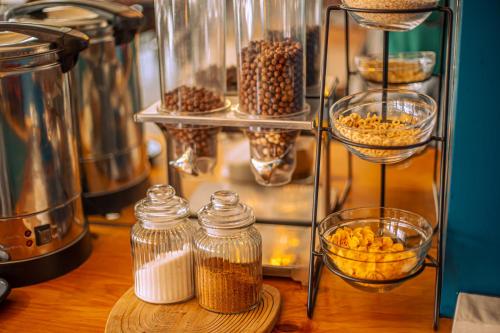 a shelf with jars of nuts and other food items at Chemodann Kazbegi in Stepantsminda